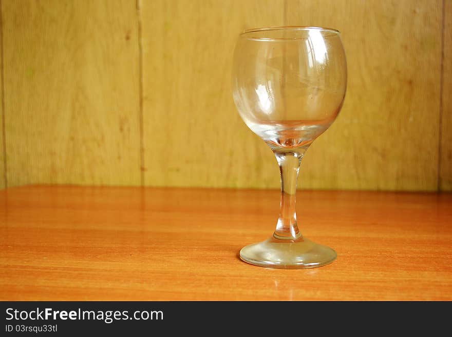 The photo of wine glass on the wooden table