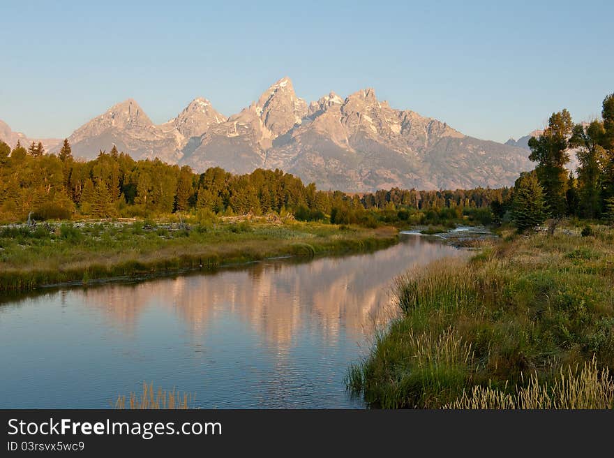 A reflection of the Grand Tetons in a stream. A reflection of the Grand Tetons in a stream