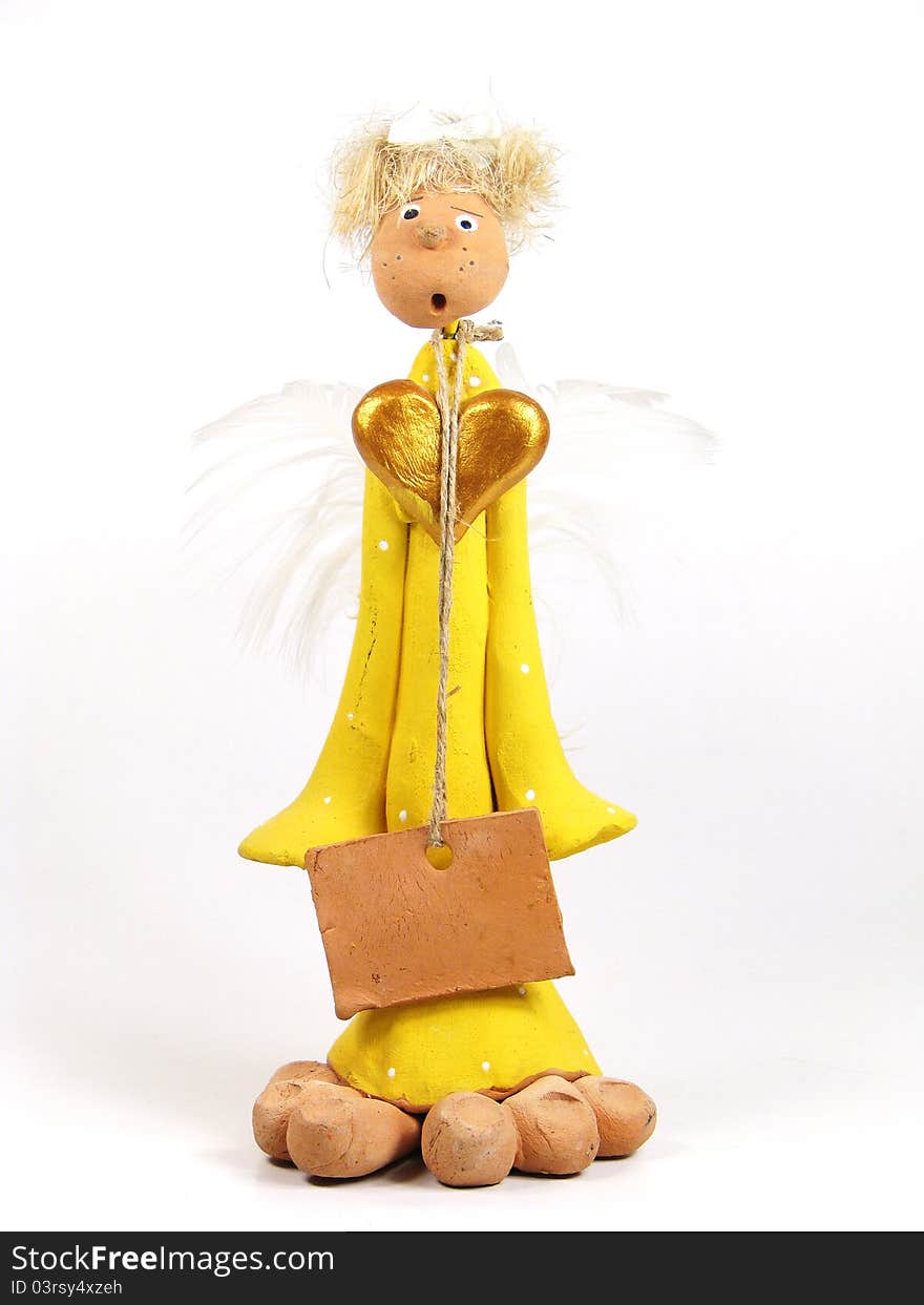 Funny angel toy with big golden heart and blank plate on the twine