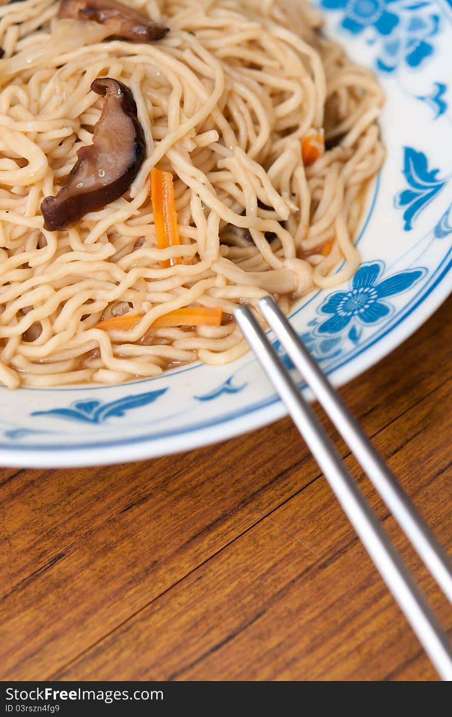 Simple dish of Chinese style white noodles and chopsticks. Simple dish of Chinese style white noodles and chopsticks.