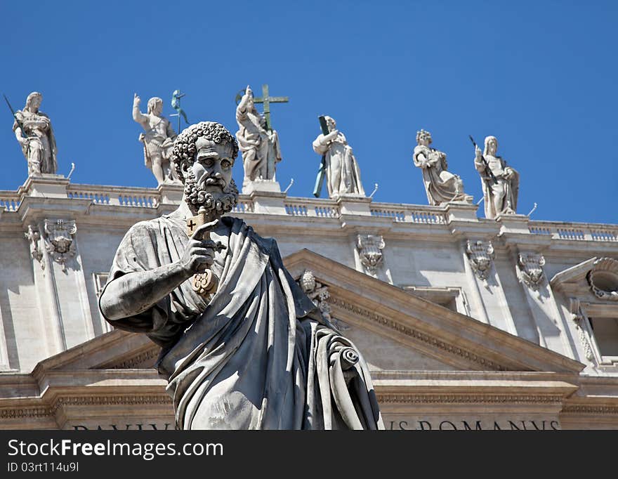 St Peter statue in St. Peter Square (Rome, Italy) with blue sky background