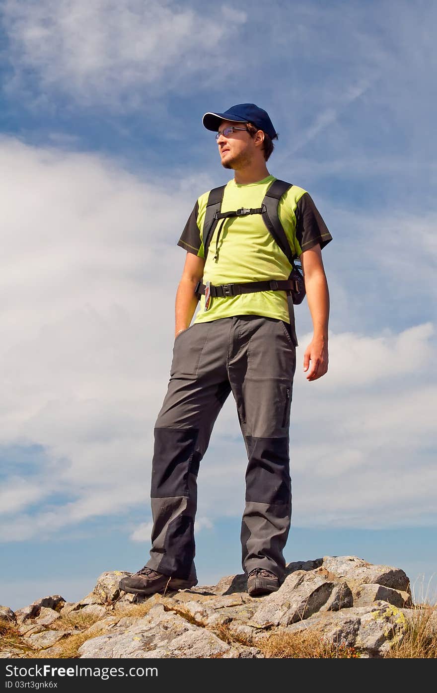 Young tourist on the top of mountain massif.