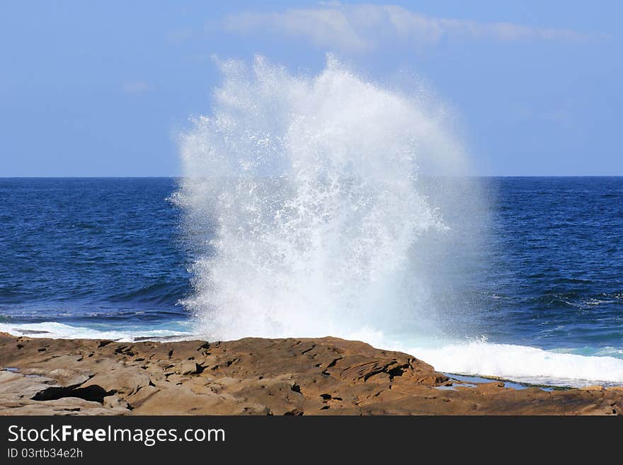 Massive spray after a wave smashed against a rock. Massive spray after a wave smashed against a rock