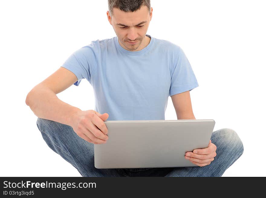 Handsome young male working on laptop computer. isolated