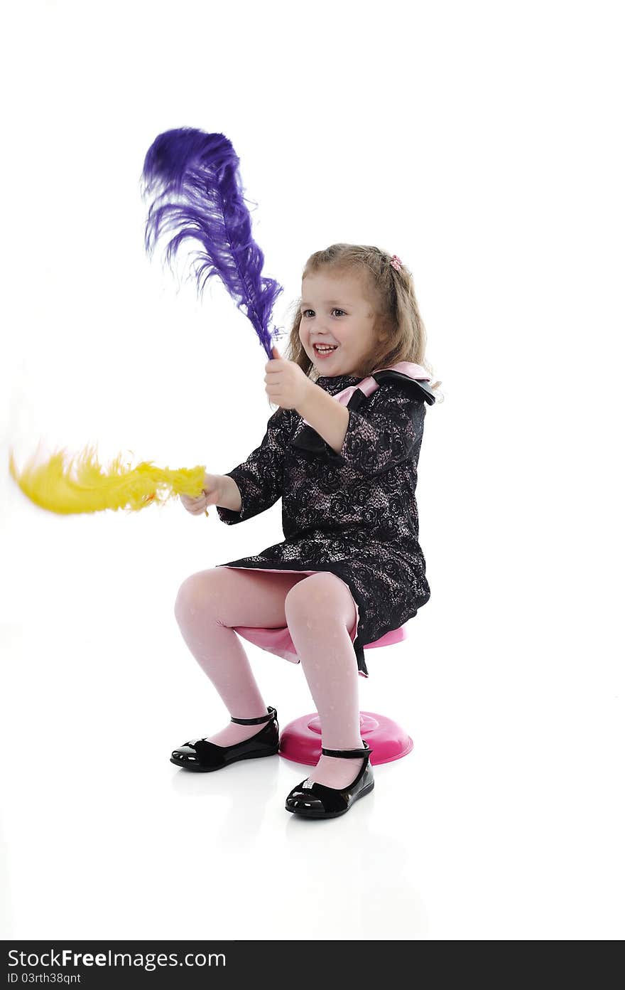 Pretty little surprised girl in black elegant party dress playing. isolated. Pretty little surprised girl in black elegant party dress playing. isolated