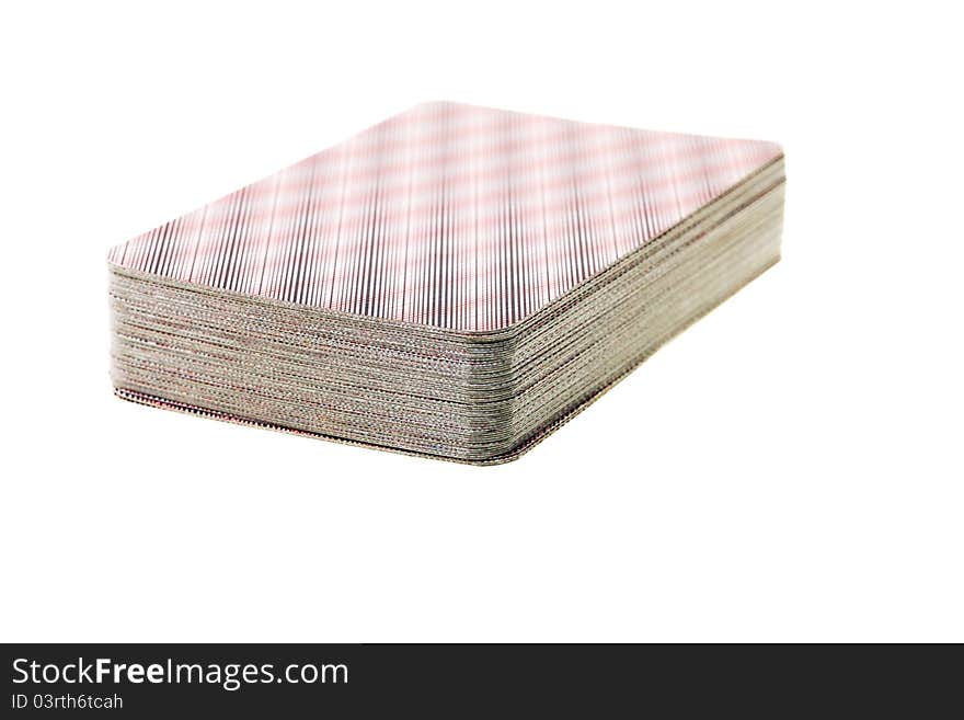 The playing cards combined in one pile (object on a white background, small depth of sharpness, focus on the foreground)