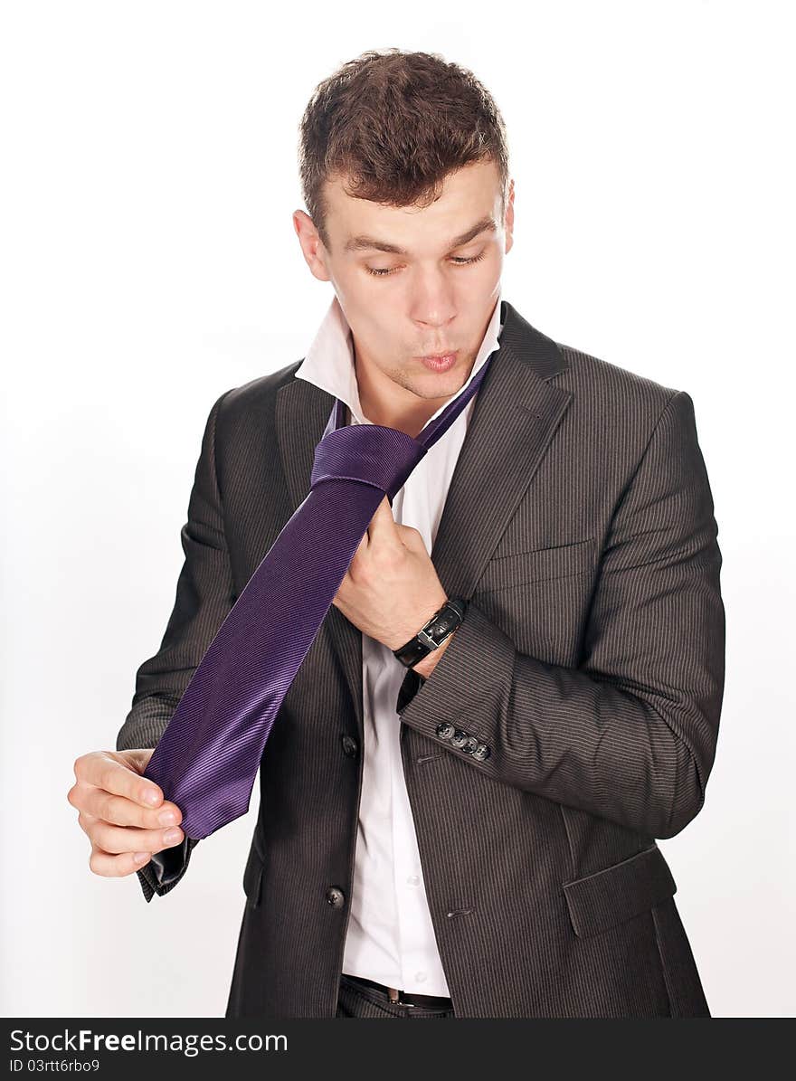 Closeup Of Businessman Tying His Tie Against White