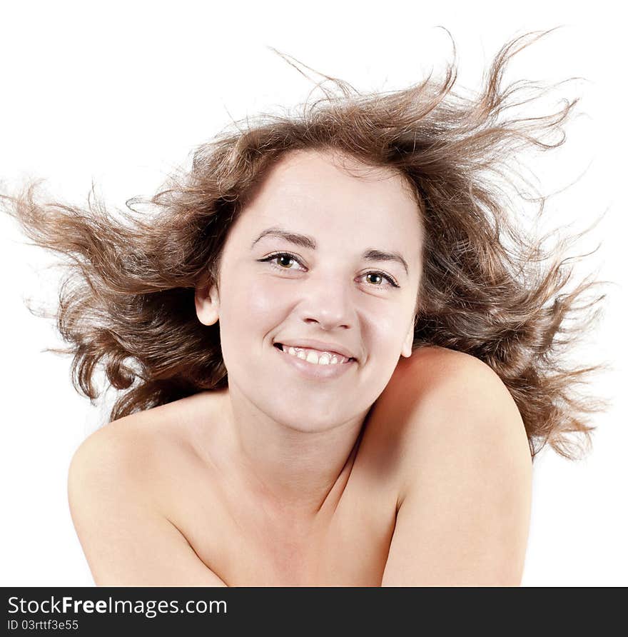 Woman with hair blown by wind on white