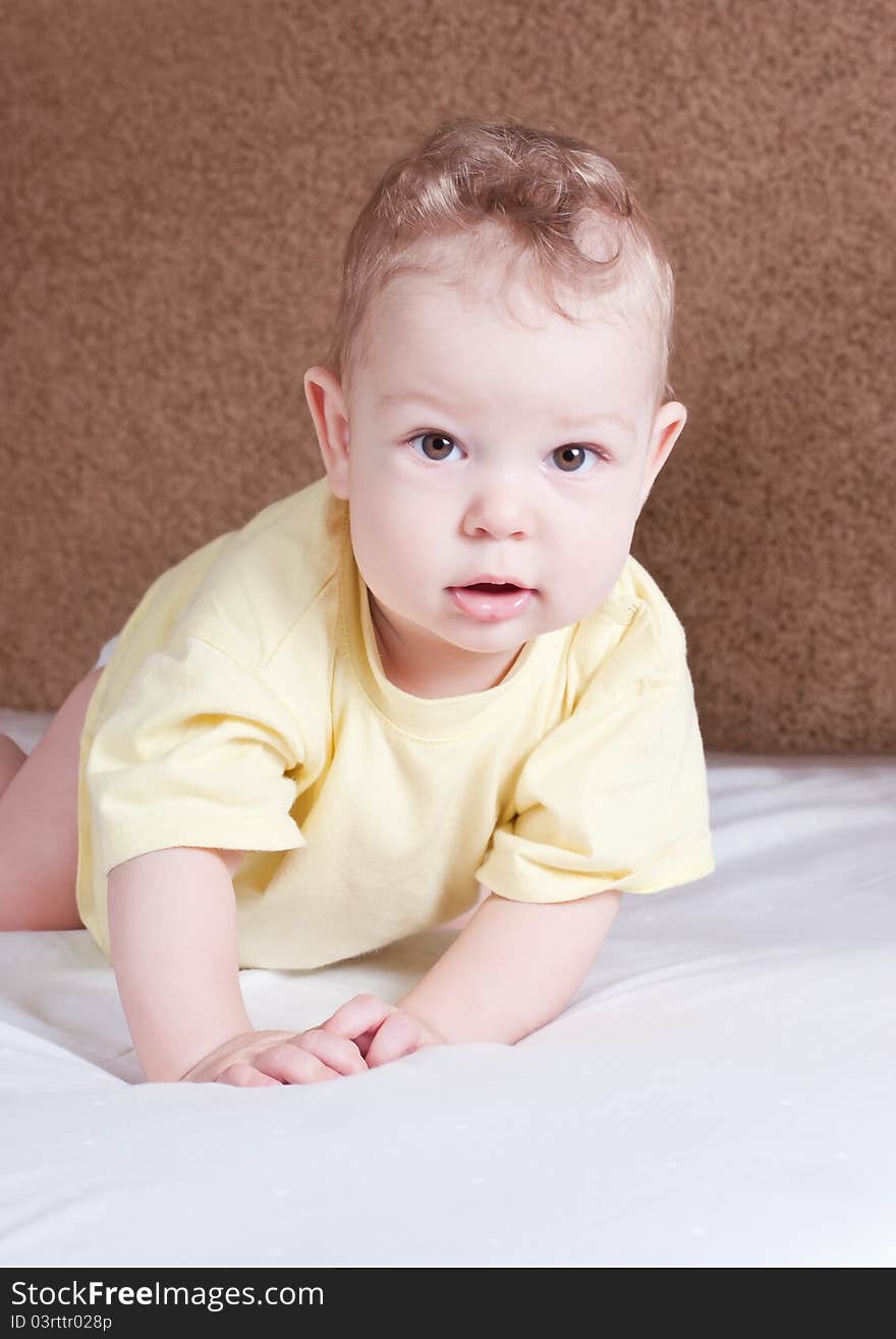 Curious baby on white bed. Curious baby on white bed