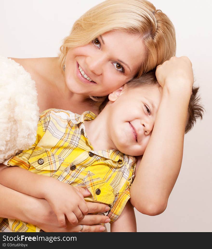 Happy Mother With Her Child Together On A White