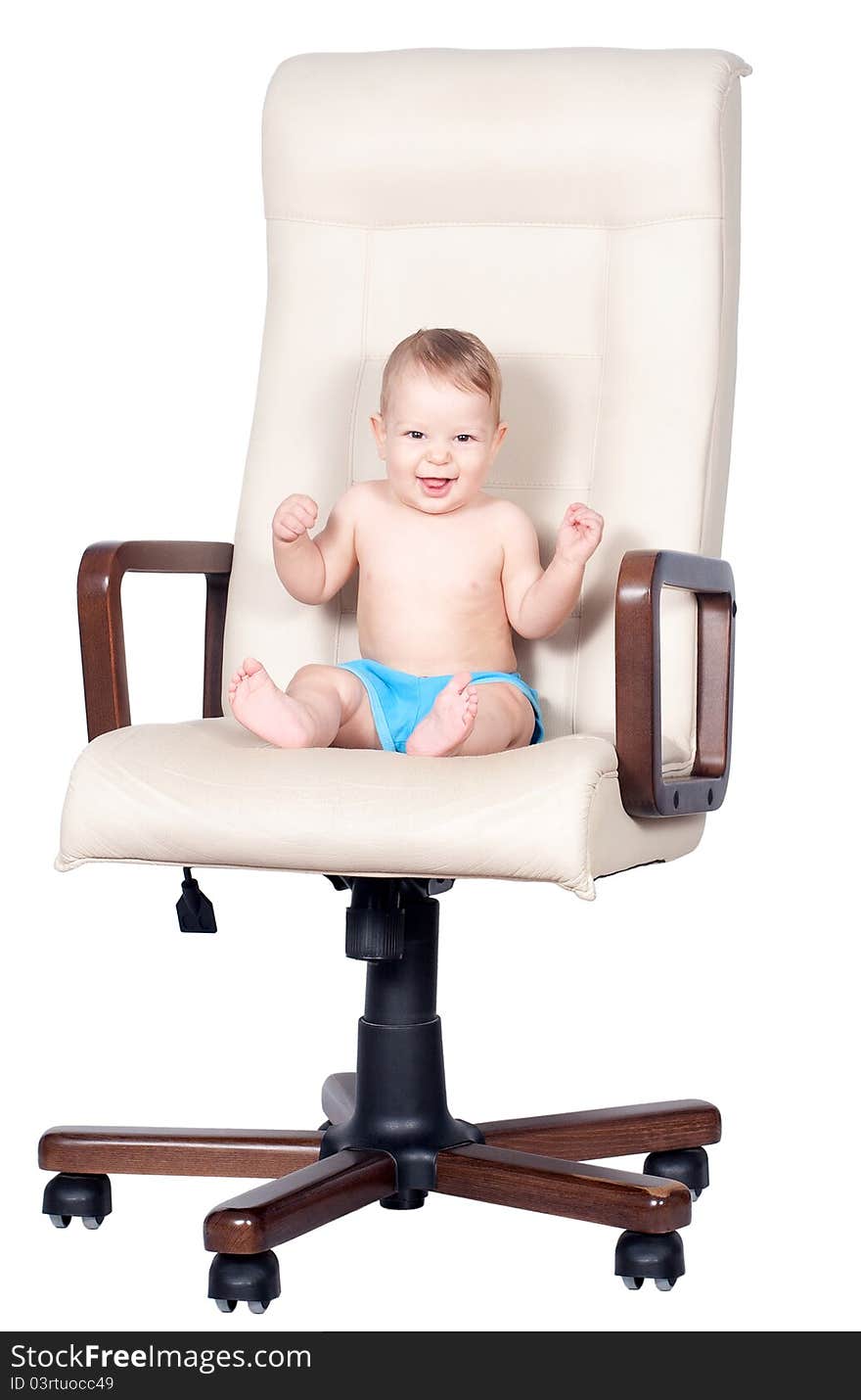 Baby boy sits in office chair on white