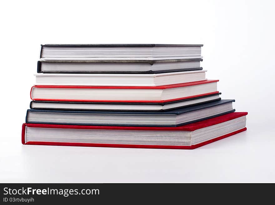 Stack of colorful books on white background