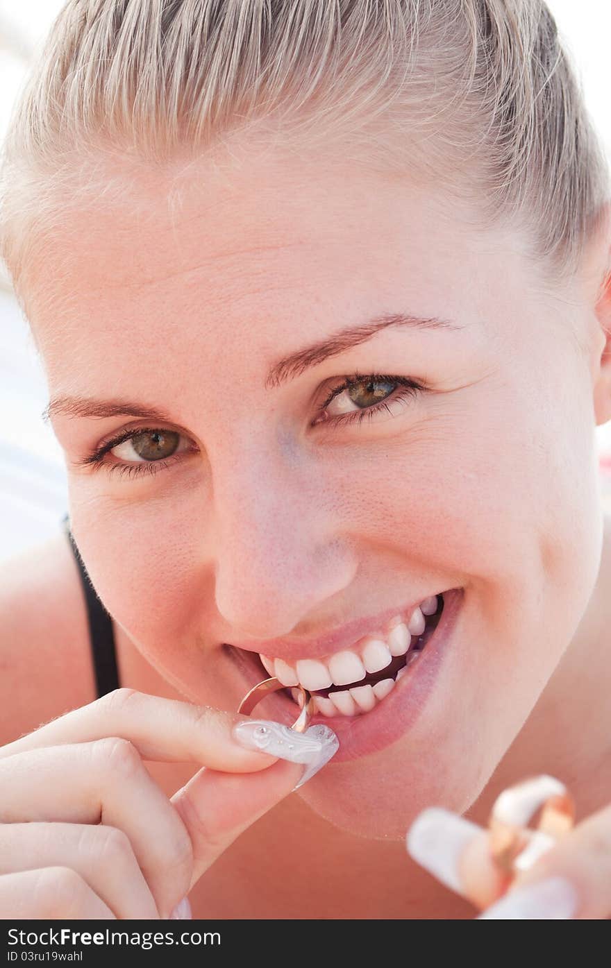 Young woman playing with wedding rings on the beach. Young woman playing with wedding rings on the beach