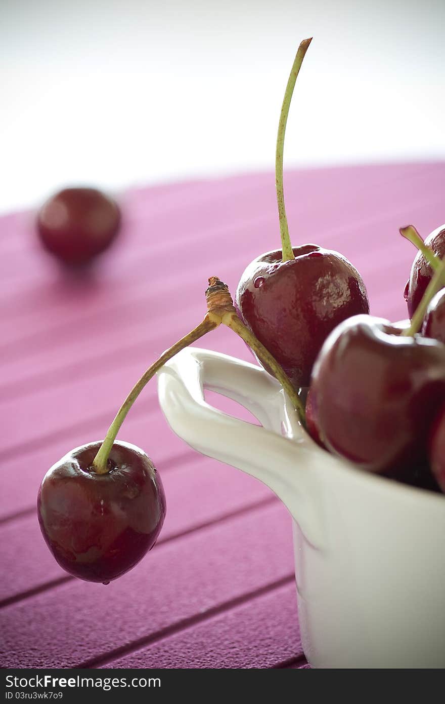 Macro image for Cherries on white plate and pink background. Macro image for Cherries on white plate and pink background