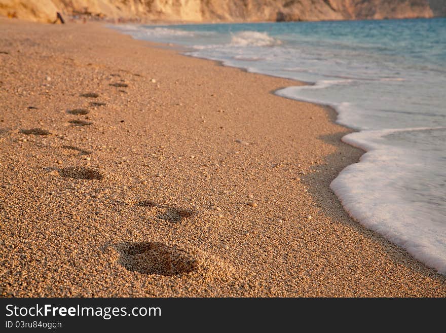 Barefoot steps on Egremni beach in Greece. Barefoot steps on Egremni beach in Greece