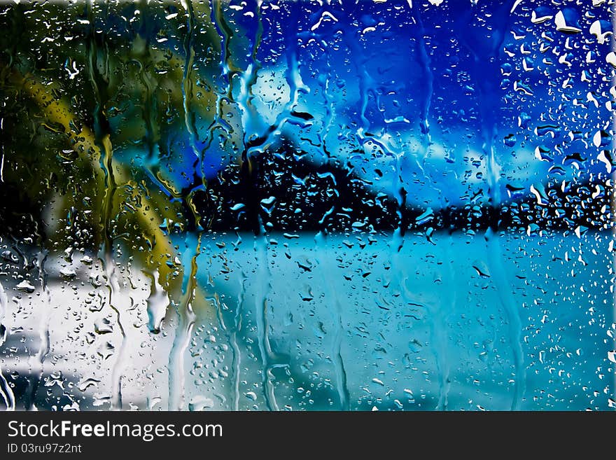 Background of sea and palm through wet window. Background of sea and palm through wet window