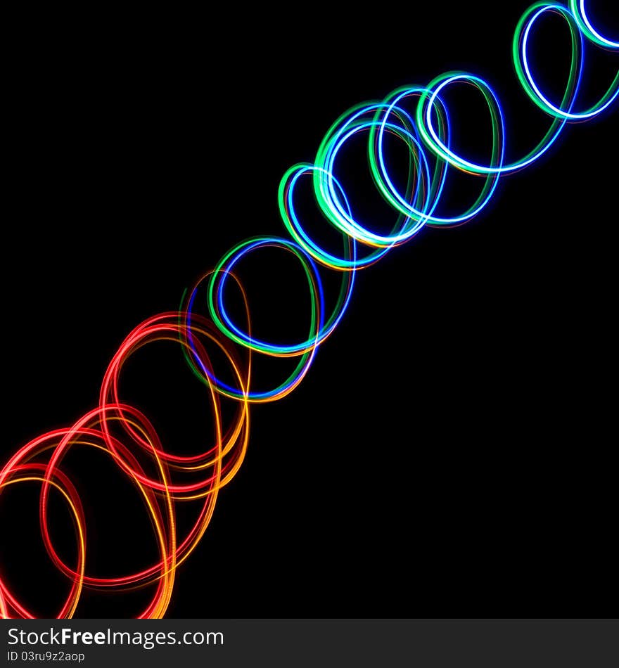 Chaotic colorful lights on black background