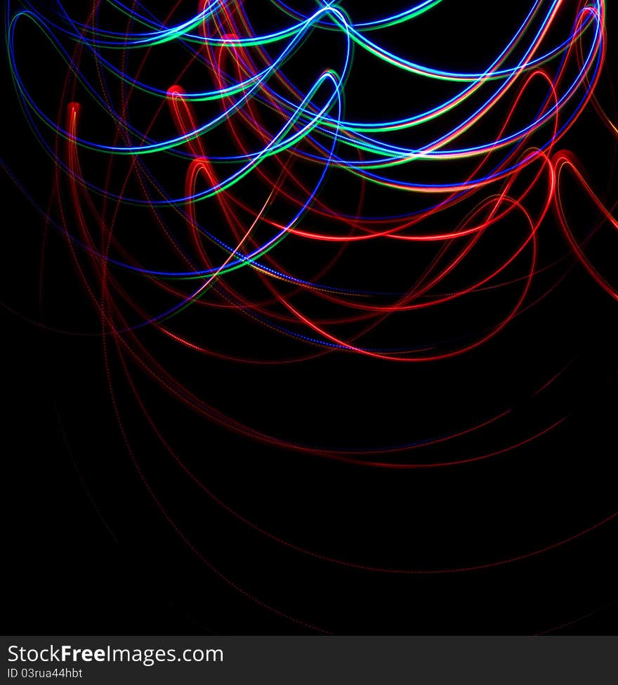 Chaotic colorful lights on black background