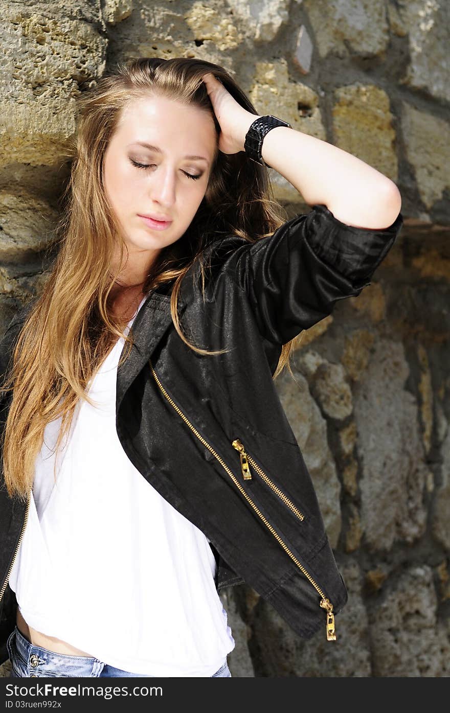 Beautiful young girl against a wall