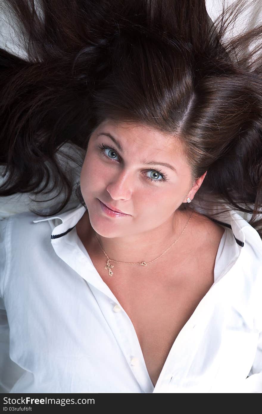 Beautiful girl lying on the snowy bed