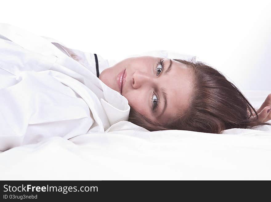 Beautiful girl lying on the snowy bed