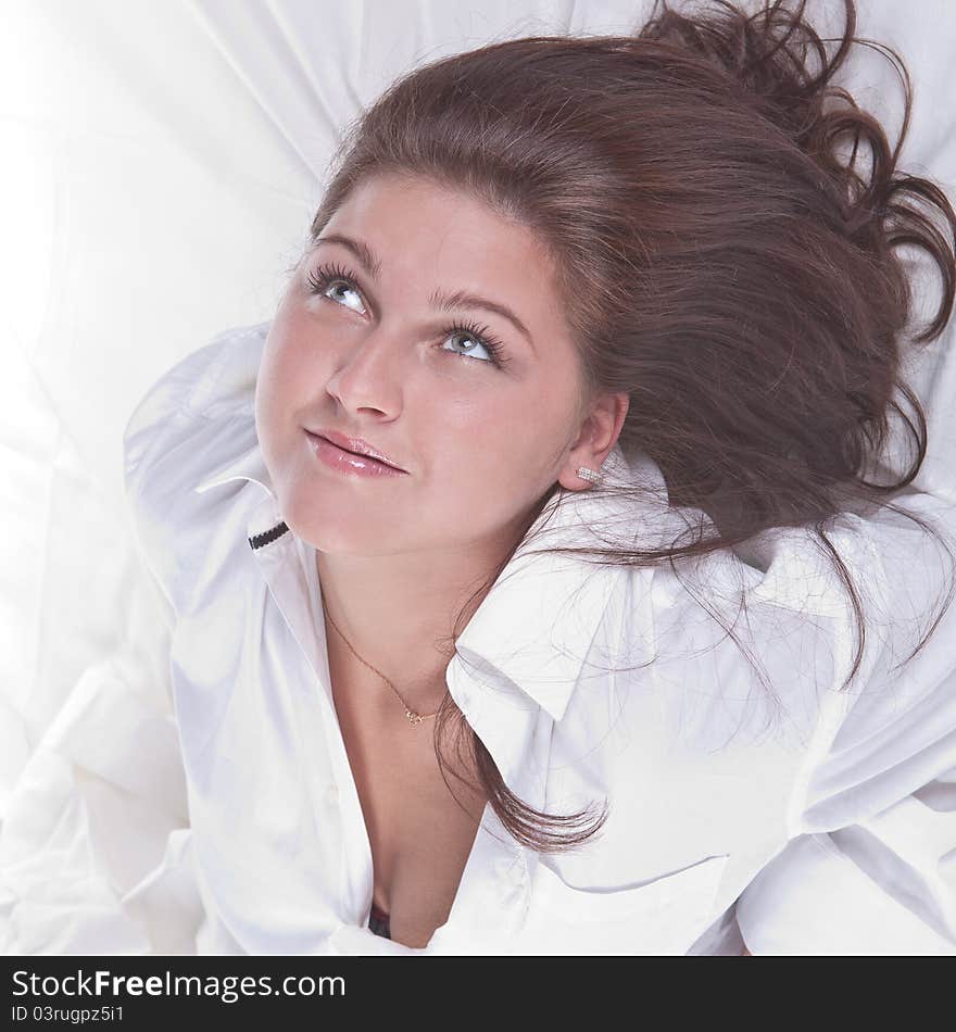 Beautiful girl lying on the snowy bed