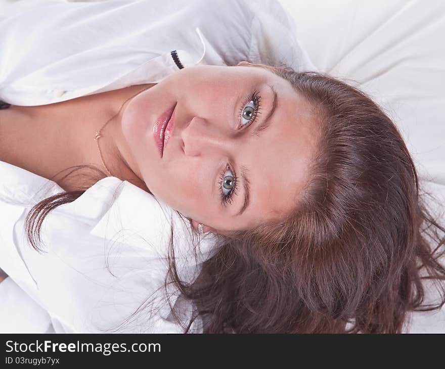 Beautiful girl lying on the snowy bed