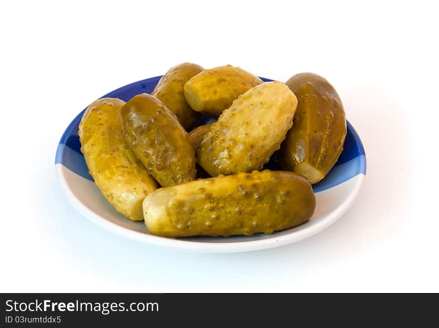 Cucumbers on a plate on a white background. Cucumbers on a plate on a white background