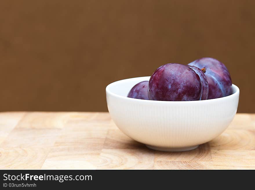 Plumbs in a White Bowl