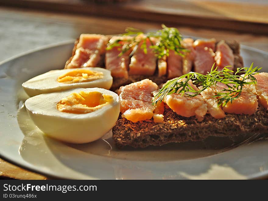 Healthy morning breakfast with rye rusks, boiled egg, salted salmon and fresh dill. Healthy morning breakfast with rye rusks, boiled egg, salted salmon and fresh dill.