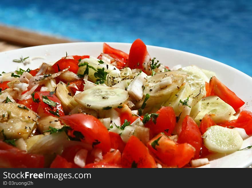 Fresh salad next to swimming pool