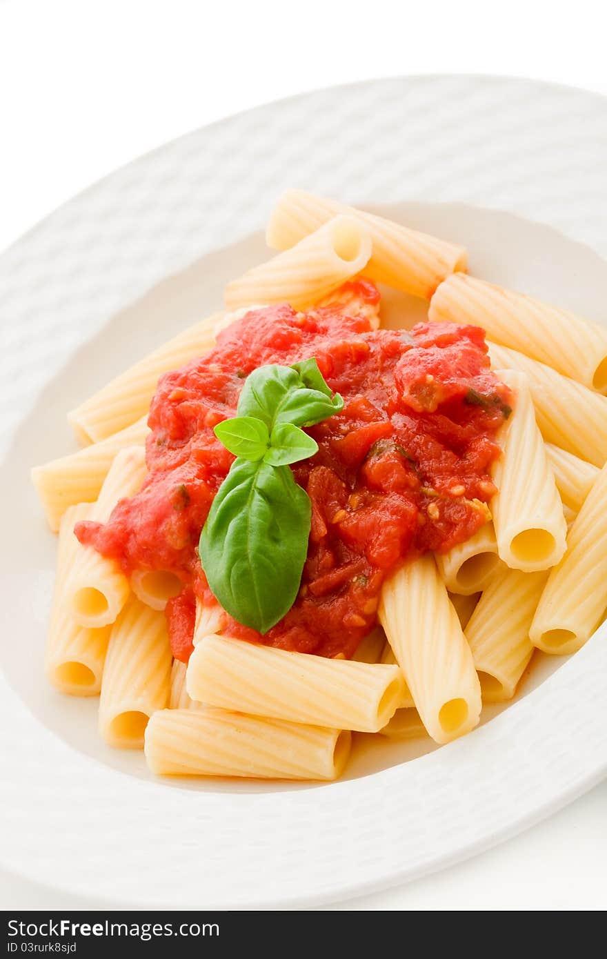 Photo of delicious pasta with basil and tomato sauce on white background. Photo of delicious pasta with basil and tomato sauce on white background