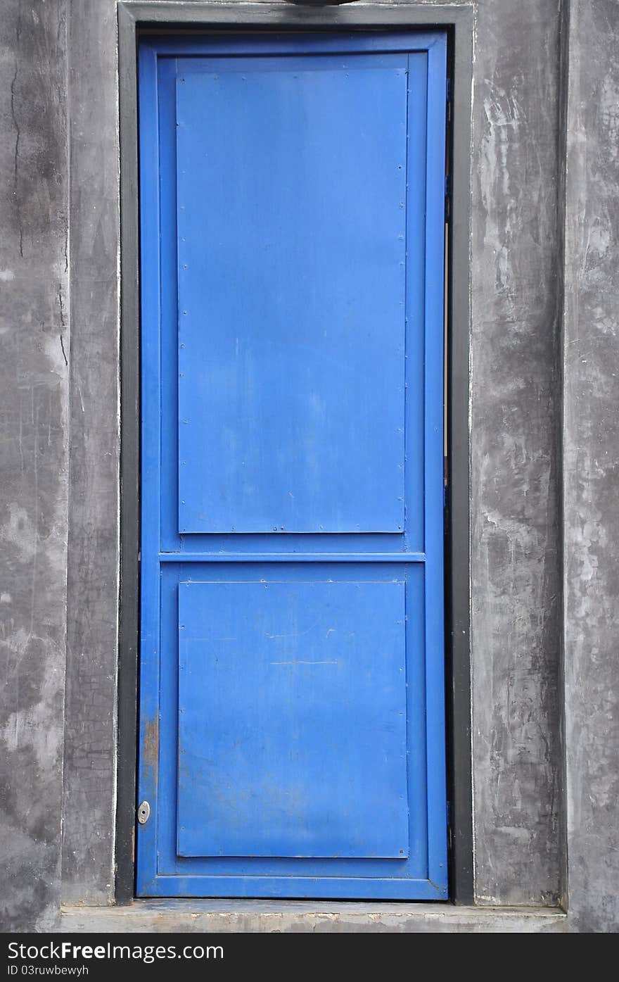 Closed blue door and grey background