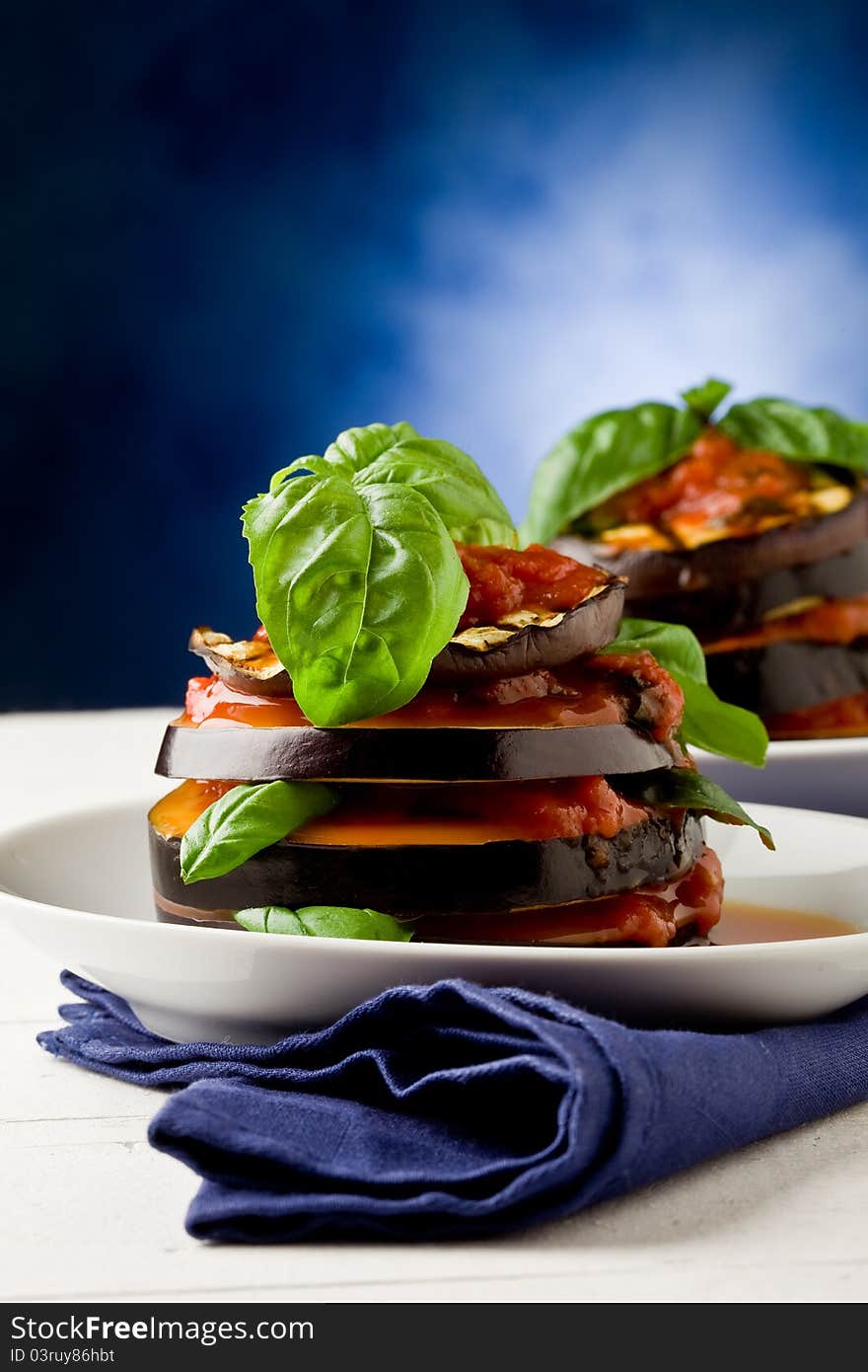 Photo of delicious aubergine dish with tomato sauce called parmigiana. Photo of delicious aubergine dish with tomato sauce called parmigiana