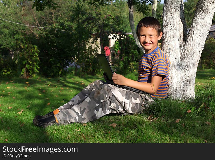 Boy On Laptop Outdoor