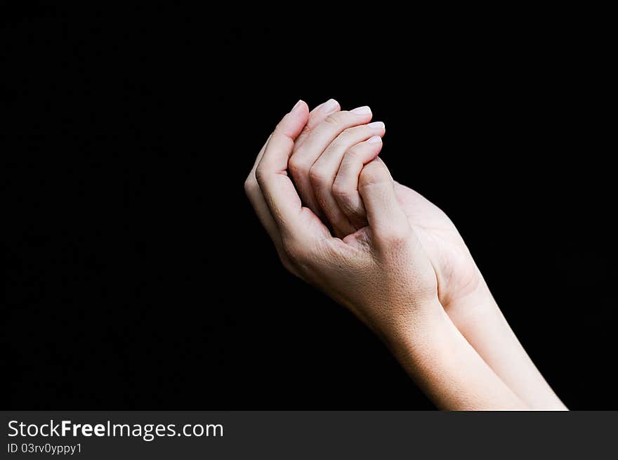 Woman hands isolated on black background.