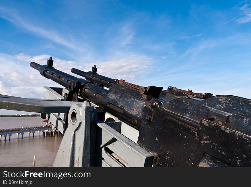 Old metal Machine gun on battleship point into sky