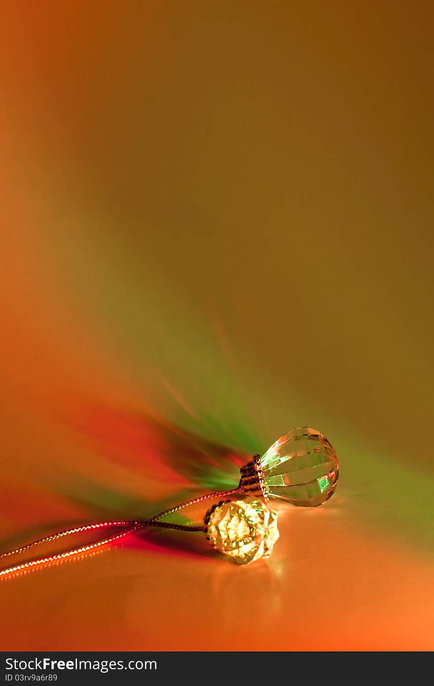 Simple crystal baubles with refractive reflections in traditional holiday-colored lighting. Simple crystal baubles with refractive reflections in traditional holiday-colored lighting.