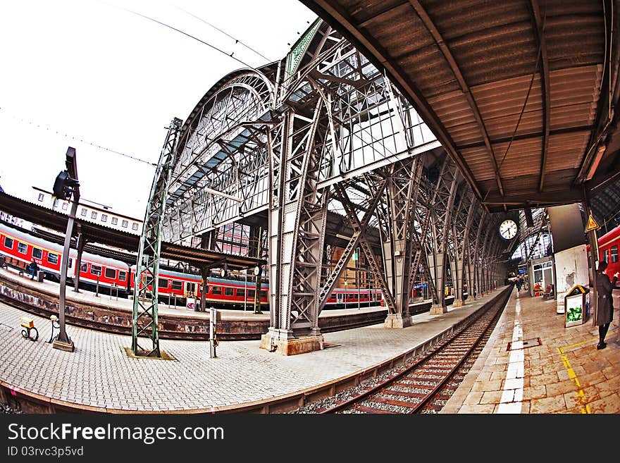 Frankfurt train station from outside with train and rails