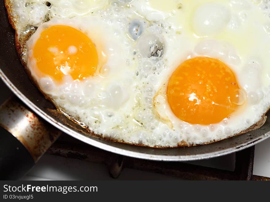 Pan full of scramble eggs in a frying pan