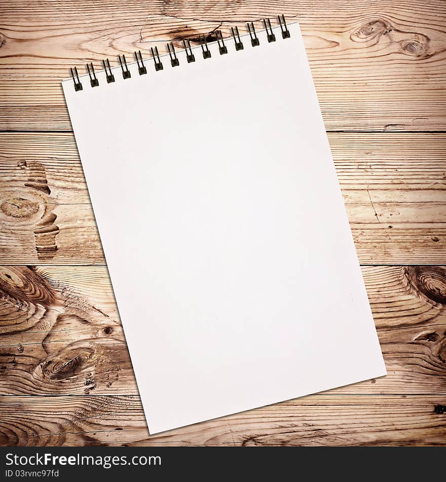 White notebook for painting on wooden background