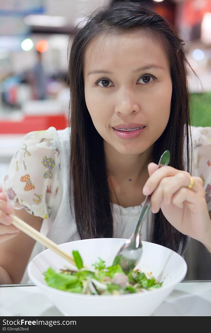 Woman eating a noodle