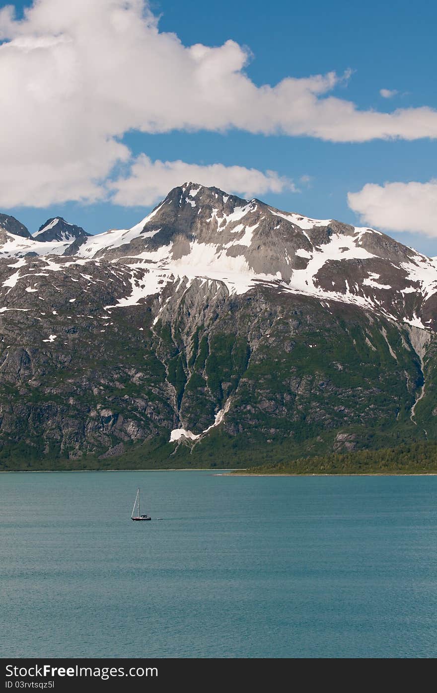 Tiny boat and gigantic mountains