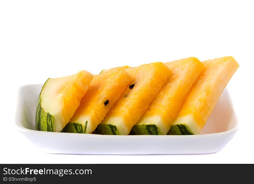 Slice yellow watermelon in a package on white background