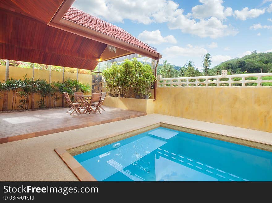 Panoramic view of nice summer house patio with swimming pool