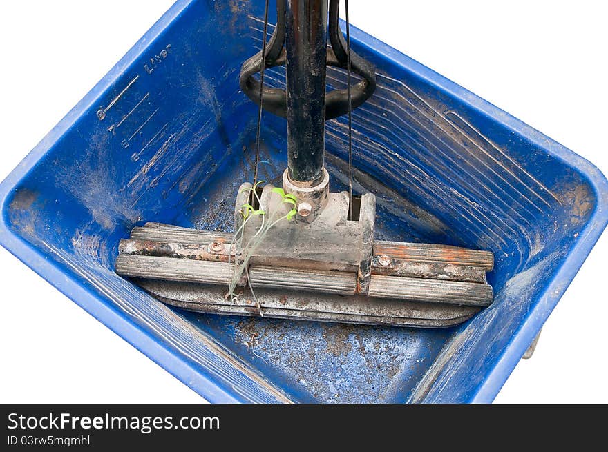 Old mop with green sprouts in a dirty bucket isolated on white background