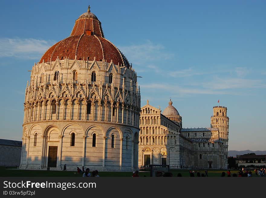 The sun setting on the Leaning Tower, Duomo and Battistero of Pisa. The sun setting on the Leaning Tower, Duomo and Battistero of Pisa