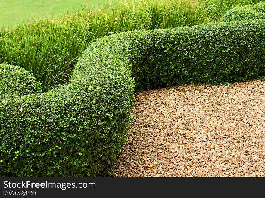 Abstract View  Green Lawn With Pebbles And Tiles