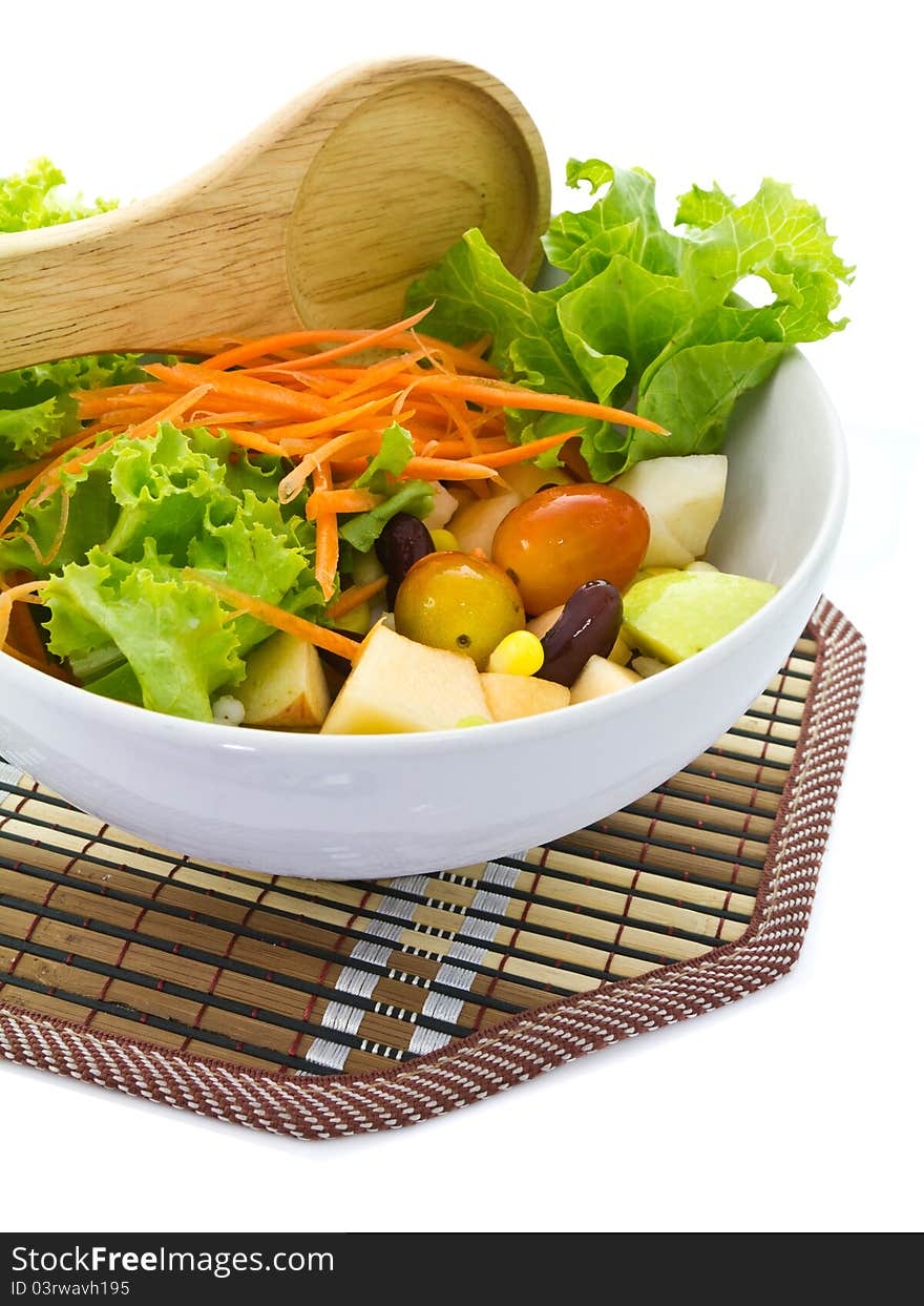 Bowl of salad with wooden spoon