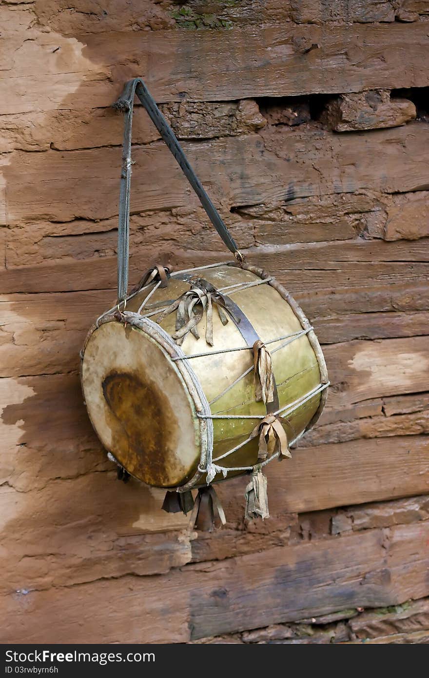 Vintage drum ritual, against a wooden wall